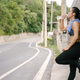 Young Asian woman runner resting after workout running and drinking water in street road. - PhotoDune Item for Sale