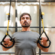 Strong man exercising with TRX bands - PhotoDune Item for Sale