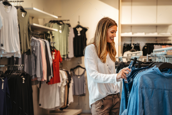 Beautiful woman buying clothes Stock Photo by nd3000