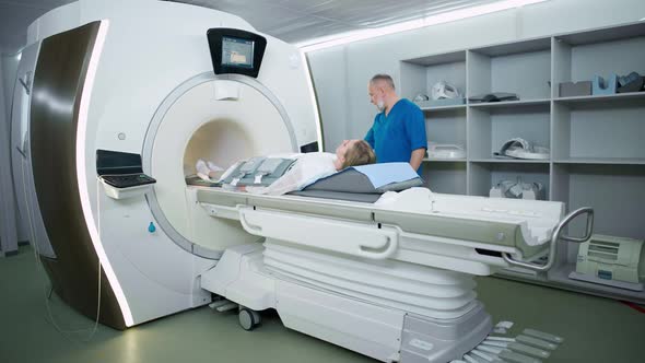 Magnetic Resonance Imaging in the Modern Hospital Adult Man Doctor Performs a Magnetic Tomographic alt