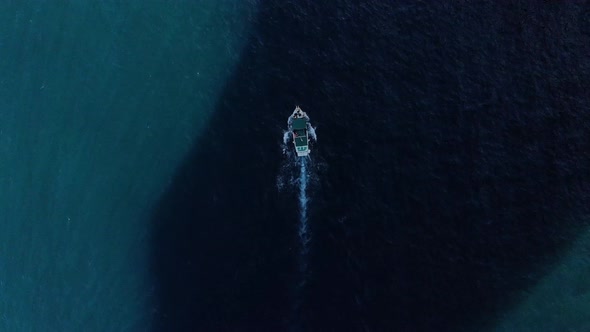 Aerial View of a Moving Fishing Boat in the Ocean alt