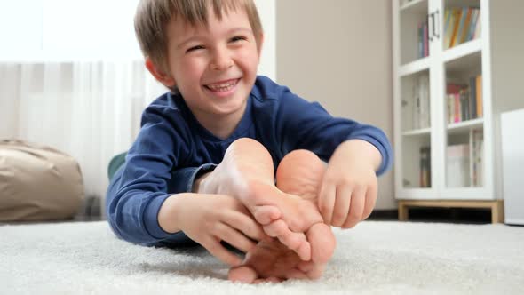 Funny Laughing Boy Lying on Mother and Tickling Her Feet, Stock Footage