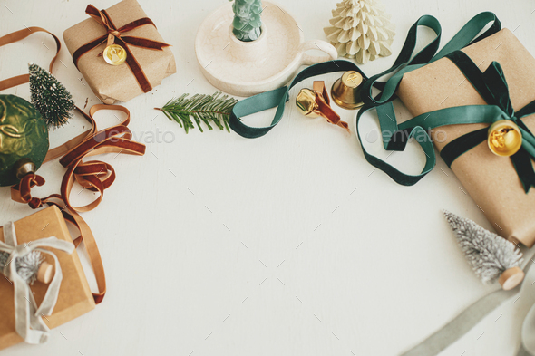 Christmas flat lay. Stylish christmas gift wrapped in gold paper and green  ribbon. Merry Christmas Stock Photo by Sonyachny