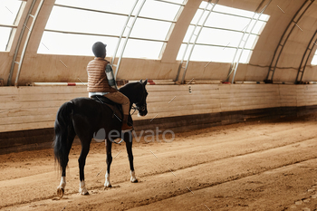 Woman Riding Horse Indoors
