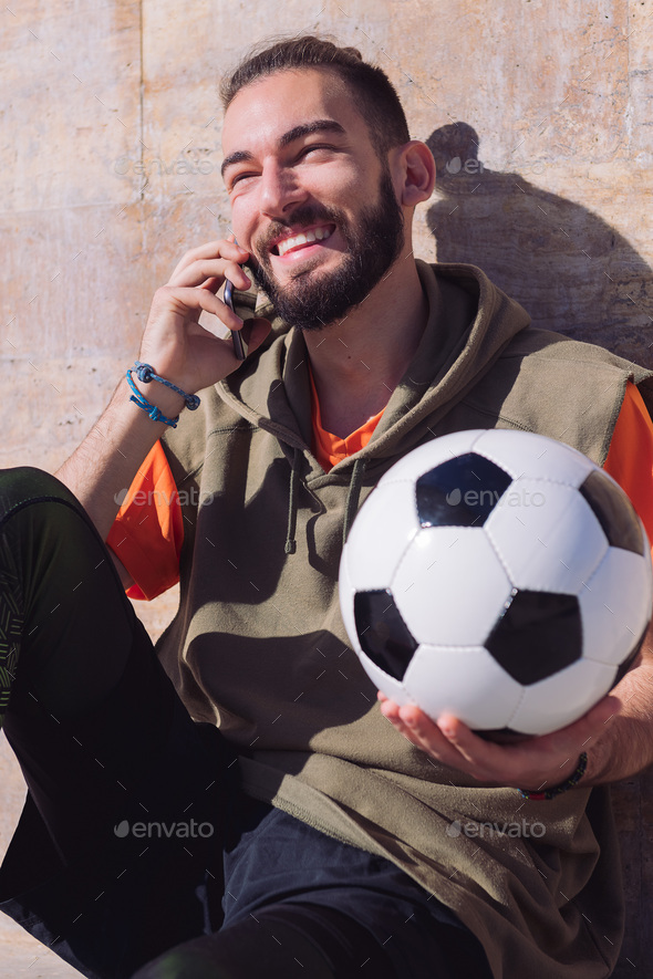 sportsman laughing and talking by phone