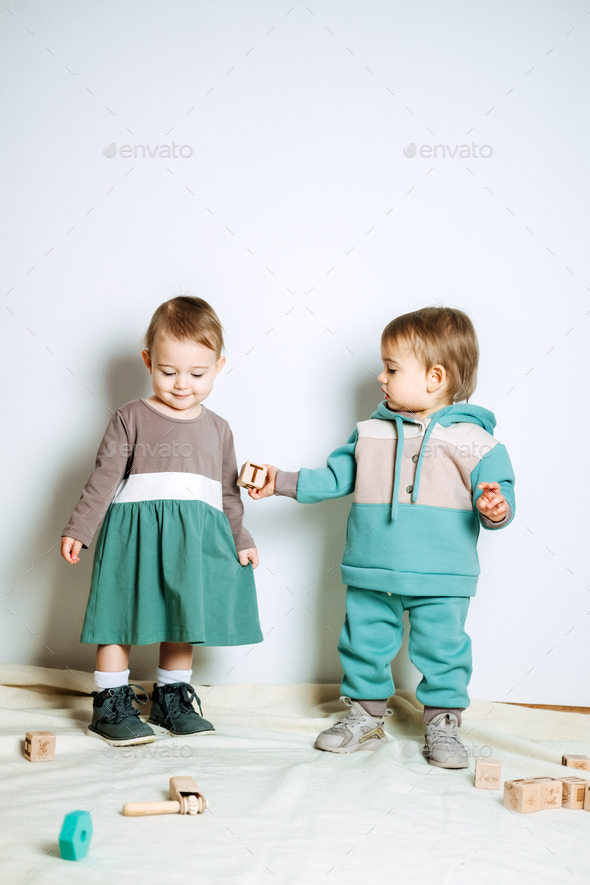 Baby fashion. Unisex gender neutral clothes for babies. Two Cute baby girls