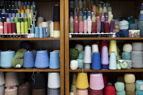 Shelves covered in spools of colorful yarn waiting for crocheting or knitting. - Stock Photo - Images