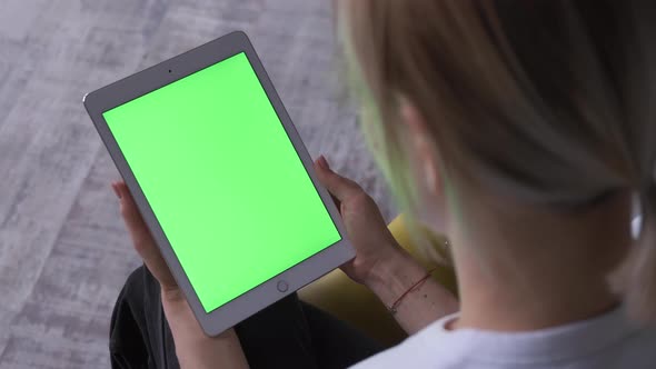 Woman With A Tablet Pc In Hands With A Green Screen, Chroma Key. alt