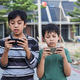 Asian Boys playing phone gadget - PhotoDune Item for Sale