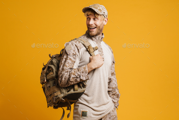 White military man smiling and while posing with backpack
