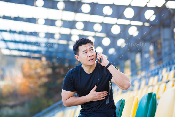 Male asian runner has severe chest pain, heart ache after running and training