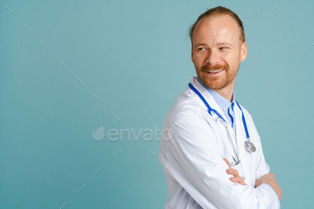 White male doctor wearing lab coat smiling and looking aside