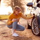 Woman Broken Down On Country Road Checking Car Tyre For Puncture - PhotoDune Item for Sale