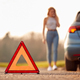 Hazard Warning Triangle Sign For Car Breakdown On Road With Woman Calling For Help In Background - PhotoDune Item for Sale