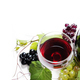 Top view of glass of red wine and bottle with grape vine - PhotoDune Item for Sale