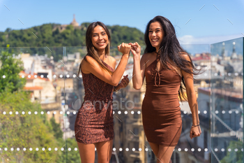 Two friends on a hotel terrace enjoying and smiling on summer vacations