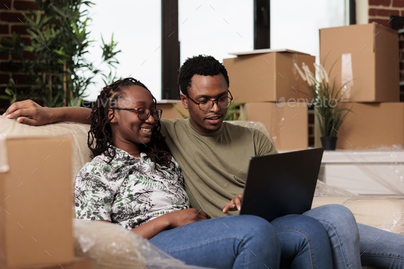 African american partners finding furniture on online website