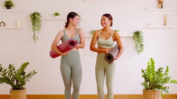Happy Couple Asian young woman hold yoga mat smile and laughing together ready to exercise yoga priv alt