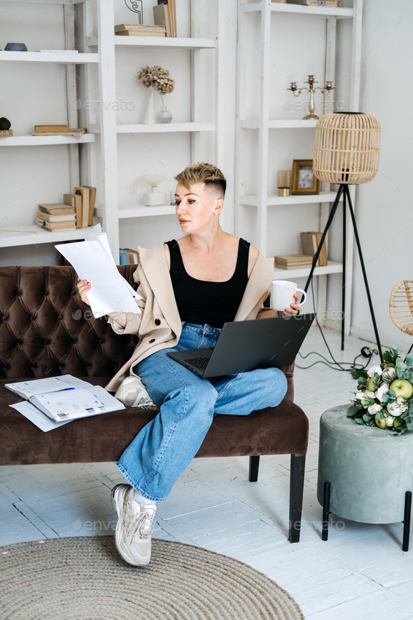 Beautiful hipster woman freelancer copywriter in casual cloth using laptop, writing article