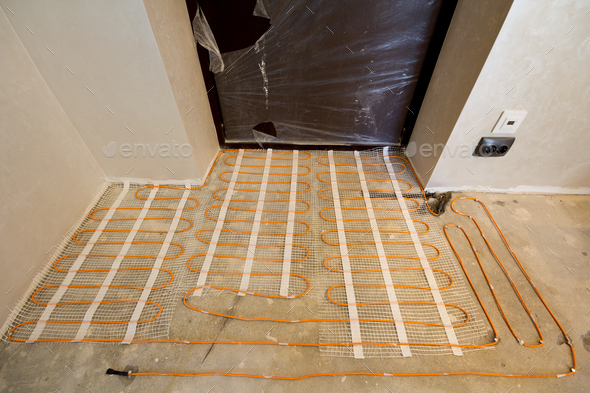 Heating red electrical cable wire system installed on cement floor