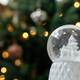 Stylish christmas snow globe against christmas tree in lights. Merry Christmas! Atmospheric winter - PhotoDune Item for Sale