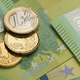 Euro coins on the green hundred bills. - PhotoDune Item for Sale