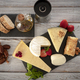 Assortment of cheese with fruits pepper and olive oil on wooden table - PhotoDune Item for Sale
