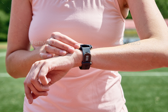 Woman use fitness smart watch, checking results after sport training