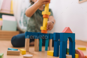 colorful wooden building blocks with child playing