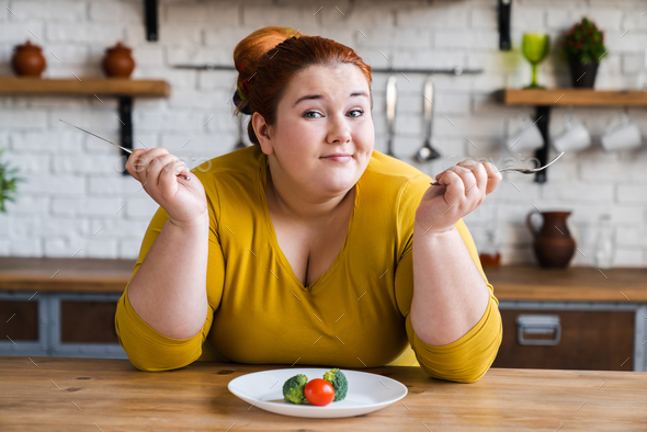 Curious fat chubby plump woman on diet for losing weight and burning calories.