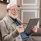 Cheerful old grandfather man doing online payment from digital tablet with credit card. - PhotoDune Item for Sale