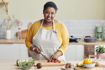 Young Black Woman Cooking in Kitchen