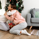 White mother and daughter hugging while decorating christmas tree - PhotoDune Item for Sale