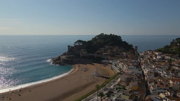 Aerial Footage of a Massive Medieval Fortress on the Shore of Tossa De Mar alt