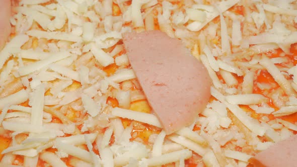 Cheese parmesan pieces and salami on   pizza base 4K 3840X2160 UHD slow panning video - Cheese sprin alt