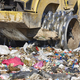 Heavy machinery shredding garbage in an open air landfill. Waste - PhotoDune Item for Sale