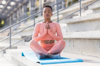 Young beautiful woman meditating in the morning, African American woman