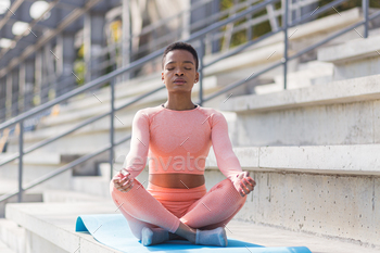 Young beautiful woman meditating in the morning, African American woman