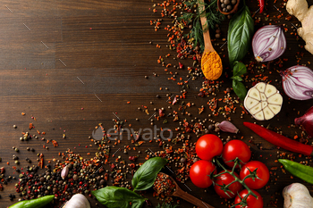 Different cooking ingredients and spices on wooden background