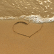 Heart drawing in the sand on the morning beach - PhotoDune Item for Sale