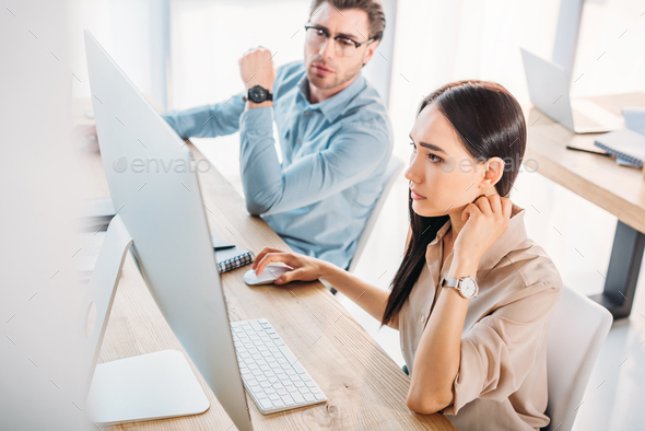 focused interracial business colleagues working on project together at  workplace in office Stock Photo by LightFieldStudios