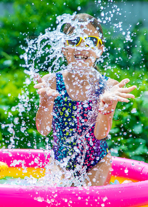 children-swim-in-the-pool-selective-focus-stock-photo-by-yanadjana