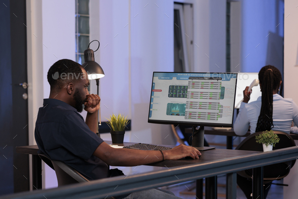 Trading manager looking at stock market exchange statistics - Stock Photo - Images