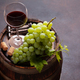Red wine glass and white grape on old barrel - PhotoDune Item for Sale