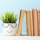 Old books and potted plant with eyeglasses - PhotoDune Item for Sale