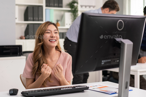 Asian female employee happy and laugh for receiving good news