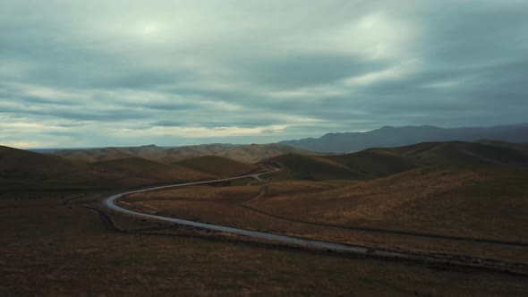 Cinematic Aerial view, highway winding through Tehachapi Mountains, California alt