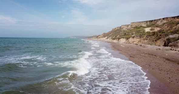 Tropical Beach Video, Aerial Bird Eye View of Blue Foaming Ocean Waves Crushing Against the Coast alt