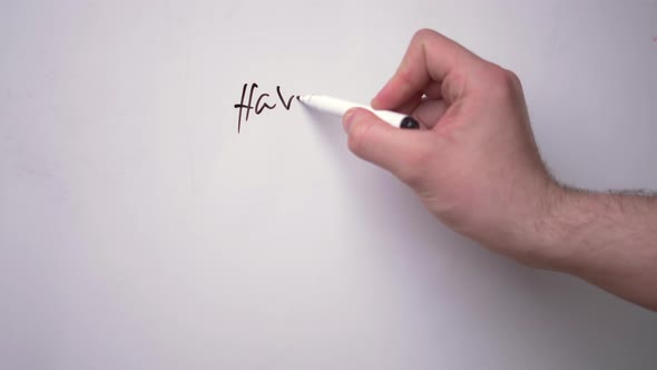 The hand of a young white guy is writing on a white magnetic board the words