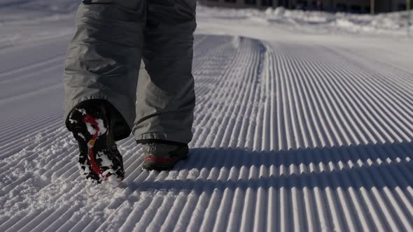 Woman Is Walking Over Snow During Winter Hiking Sporty Clothes for Winter Tourism Closeup alt